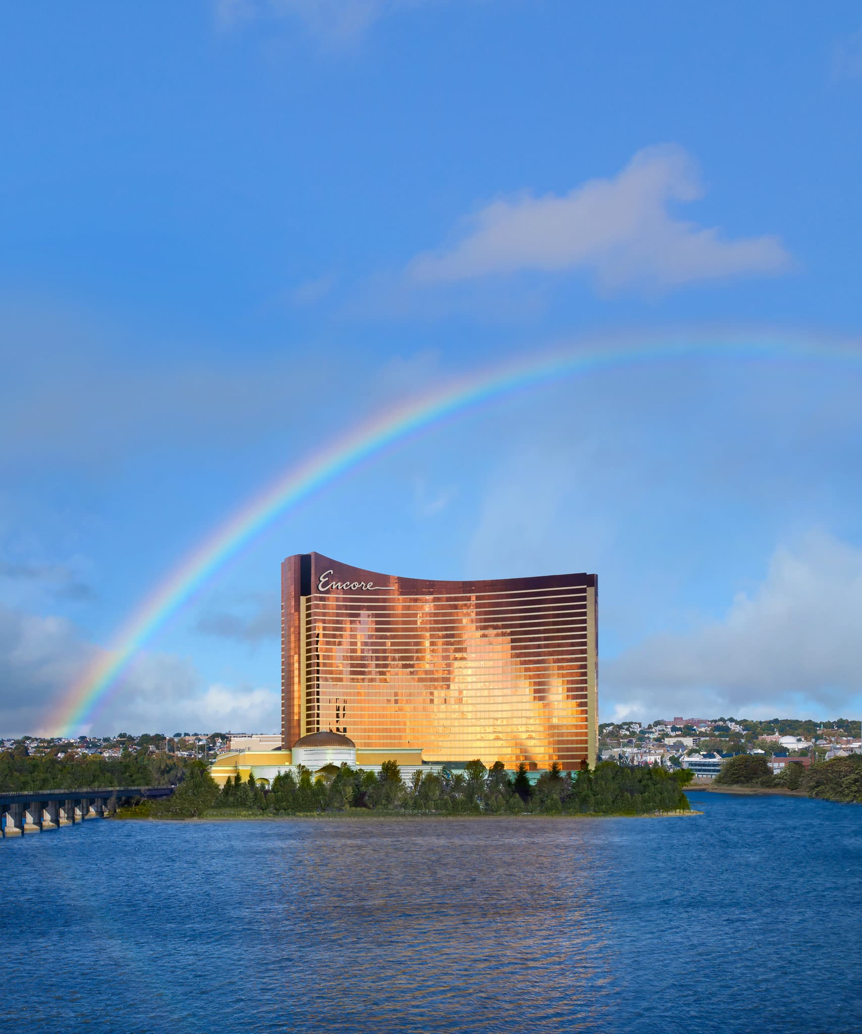 Lobby of Encore Boston Harbor featuring a vibrant floral carousel sculpture and gold-accented ceiling.