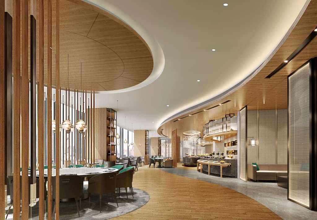 A dramatic white marble spiral staircase winding through the minimalist lobby of Radisson Blu Hangzhou Xintiandi.