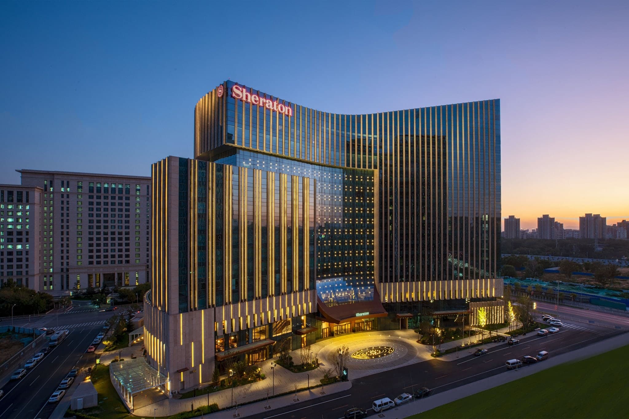 Exterior and modern lobby of the Sheraton Beijing Lize Hotel near the high-speed rail station.
