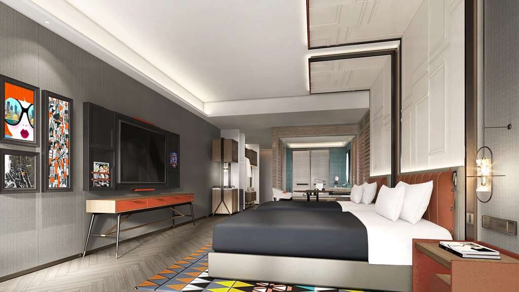 A chic, industrial-style hotel lobby featuring a sliding orange door and contemporary art installations.
