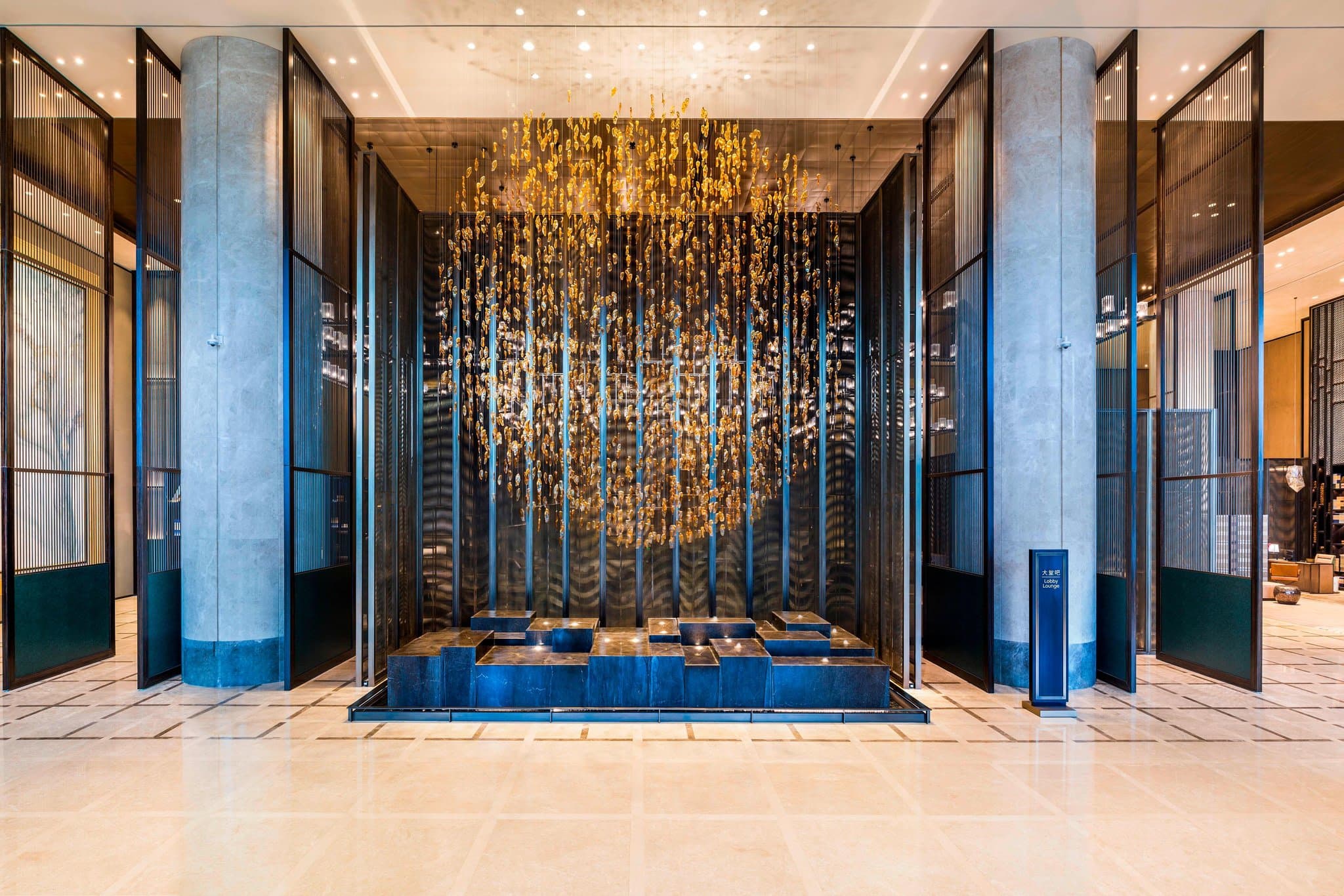 View of the sinuous Meixi Lake International Culture & Arts Centre seen through the floor-to-ceiling windows of a Marriott Executive Apartment living room.