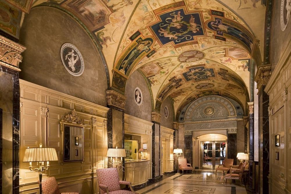 The Sherry-Netherland's ornate Gothic minaret and lobby ceiling mural reflecting 1920s Gilded Age architecture.
