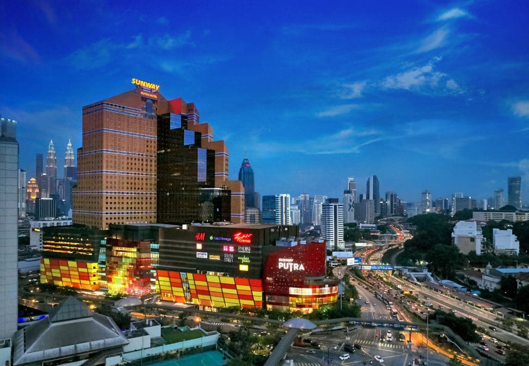 View from Sunway Putra Hotel Level 11 swimming pool deck overlooking the Kuala Lumpur skyline including KL Tower and Petronas Twin Towers.