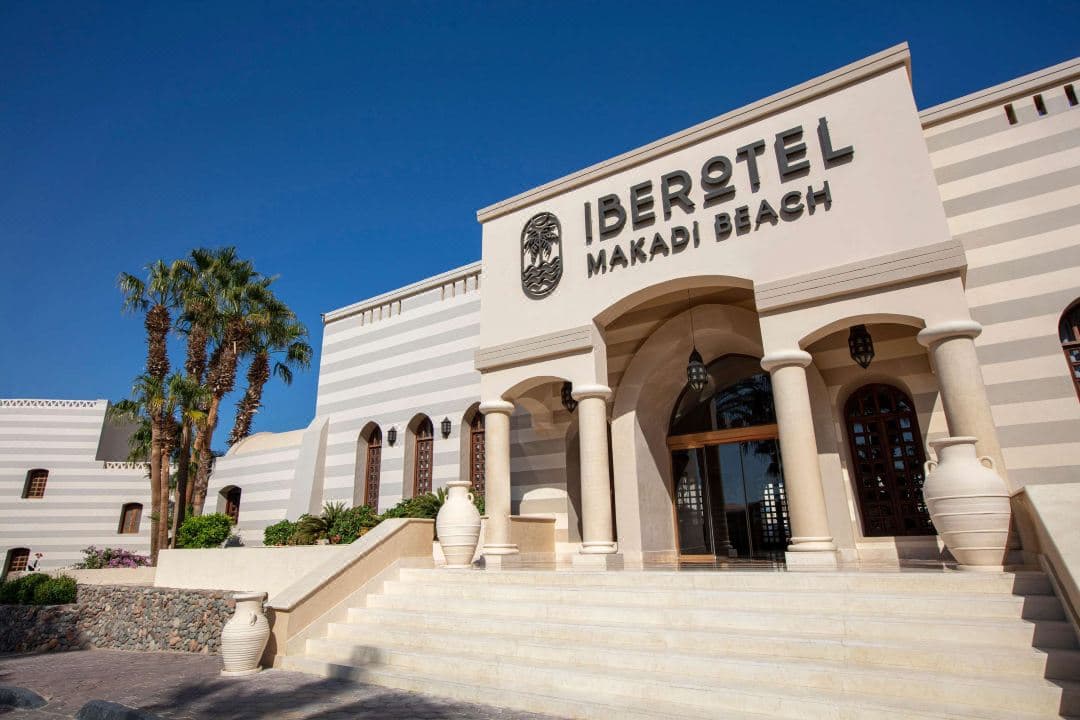Sunset view of the Iberotel Makadi Beach observation tower overlooking the pool and Red Sea coastline.