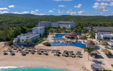 A vibrant pirate-themed water park at Royalton White Sands with slides and a tipping bucket, surrounded by palm trees.
