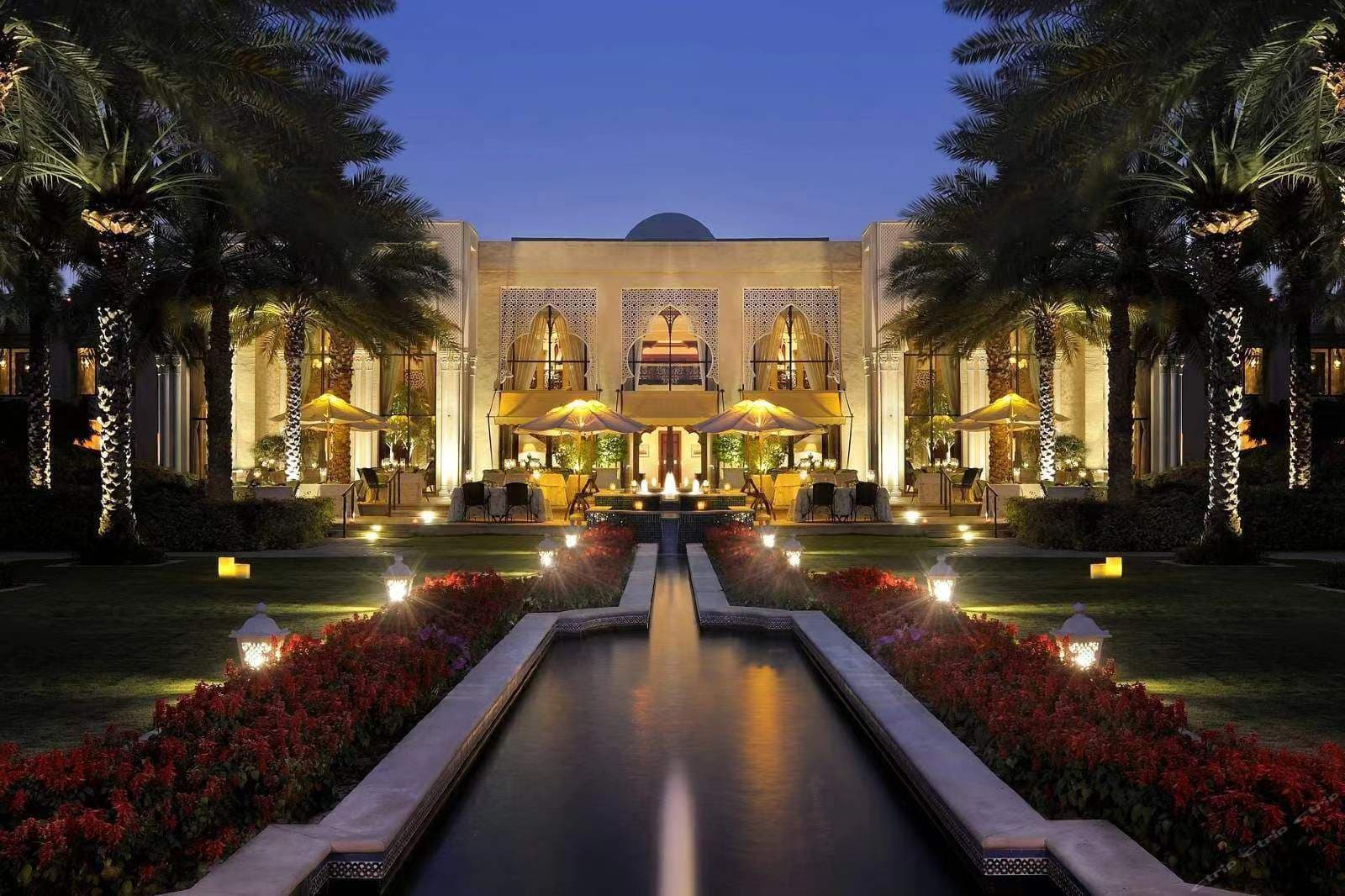 The Residence private pool framed by palm trees and traditional Arabian arches at One&Only Royal Mirage.