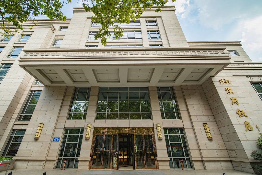 Hanfu Hotel Nanjing exterior featuring Republican-era architecture framed by Changjiang Road plane trees.
