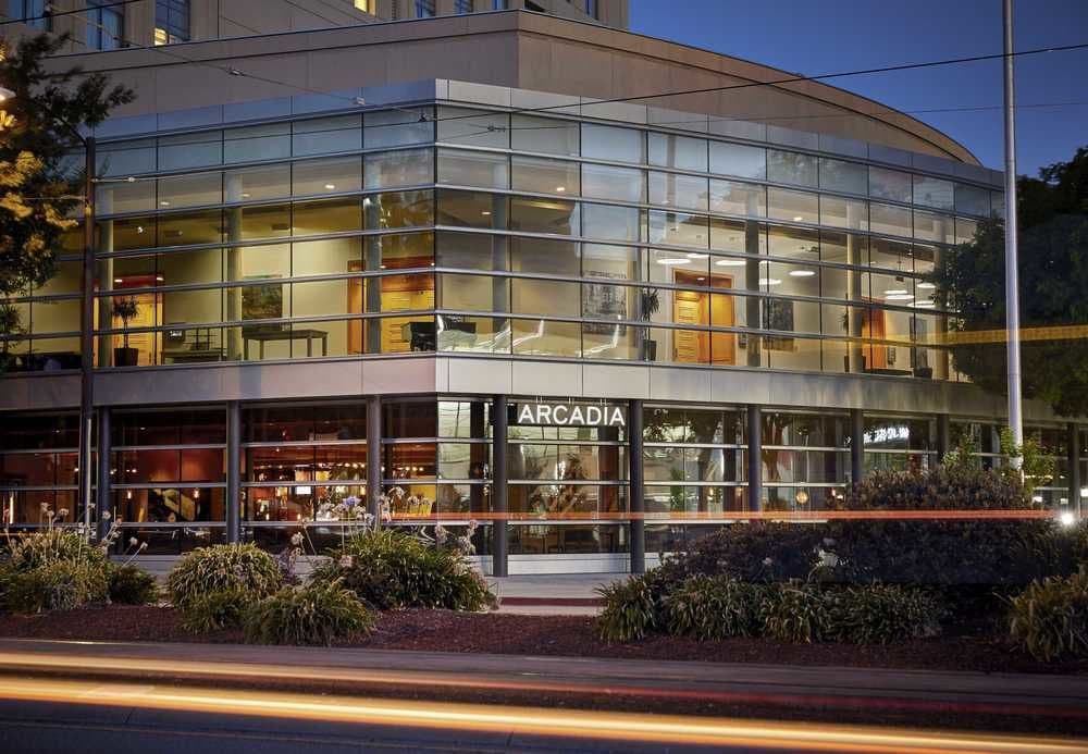 Rooftop pool deck at San Jose Marriott featuring modern fire pits and views of the Silicon Valley skyline at sunset.