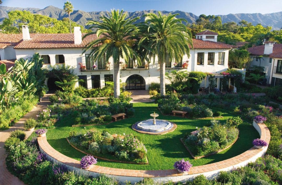 The iconic Ty Lounge terrace at Four Seasons Biltmore Santa Barbara at sunset, featuring fire pits and Spanish Colonial architecture overlooking Butterfly Beach.