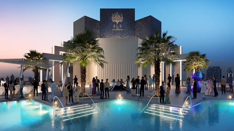 The SLS Dubai 75th-floor infinity pool at sunset overlooking the Burj Khalifa, featuring the signature SLS duck statue.