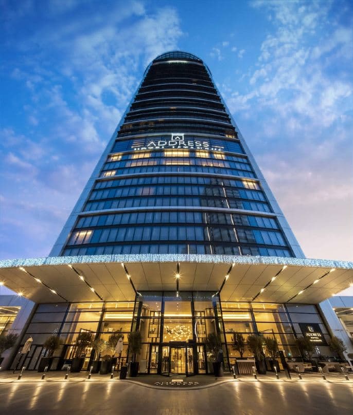 A sleek, modern hotel room interior at Address Istanbul featuring floor-to-ceiling windows with a panoramic city view and neutral luxury decor.