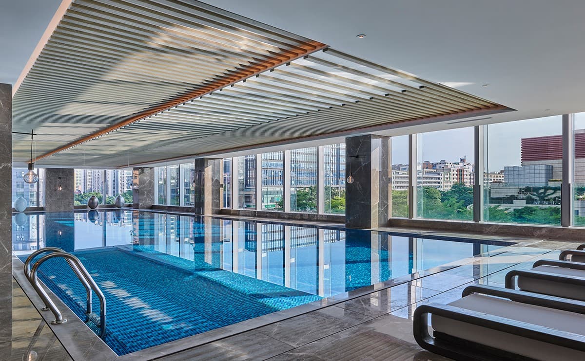 Spacious suite at Doubletree By Hilton Shenzhen Airport Residences with modern kitchen amenities and balcony.