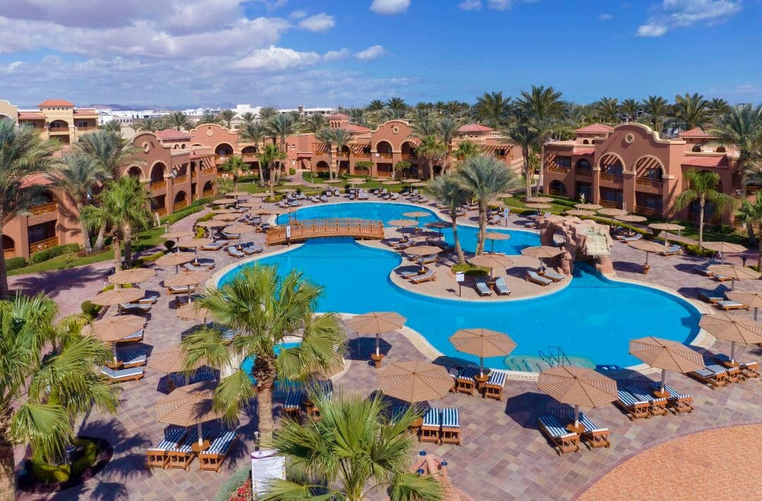 A sprawling aqua park featuring a massive wave pool and 22 winding water slides under a bright Egyptian sky.
