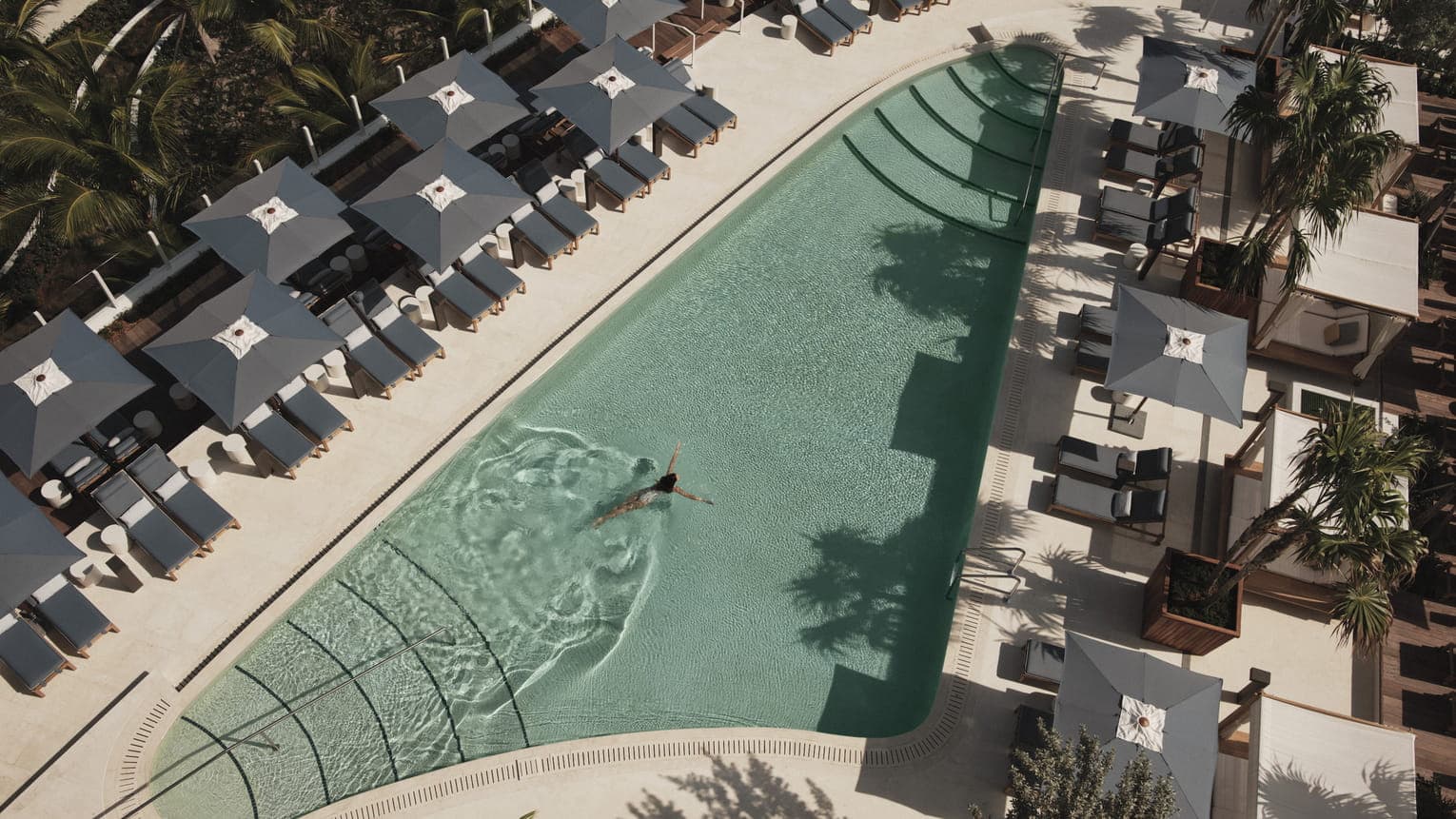 Four Seasons Fort Lauderdale ocean sun deck with white daybeds and horizon-edge pool overlooking the Atlantic Ocean.