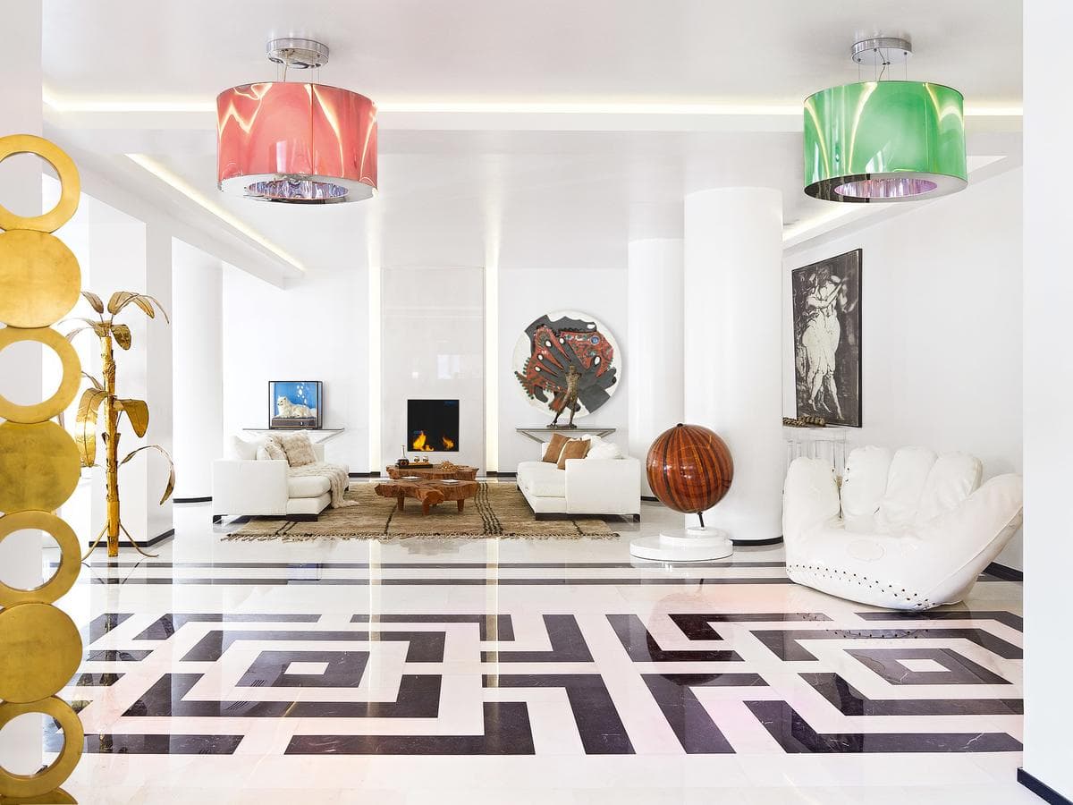 A vibrant hotel suite featuring a massive graffiti mural headboard and a quirky yellow pig sculpture.