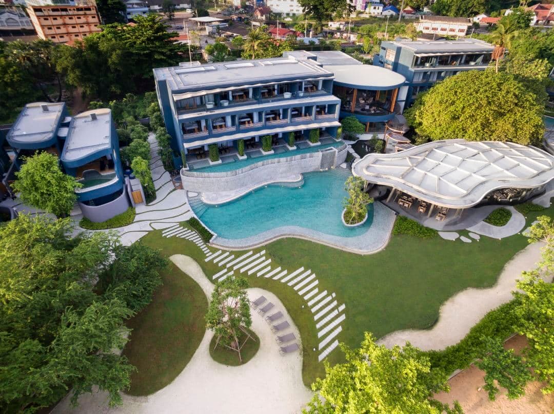 The industrial-chic Banyan Pool Villa at Navana Nature Escape, surrounded by lush tropical trees and a private plunge pool.