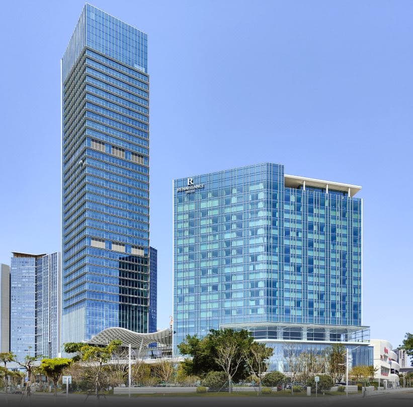 Luxurious room interior at Renaissance Zhuhai, featuring modern decor and city views.