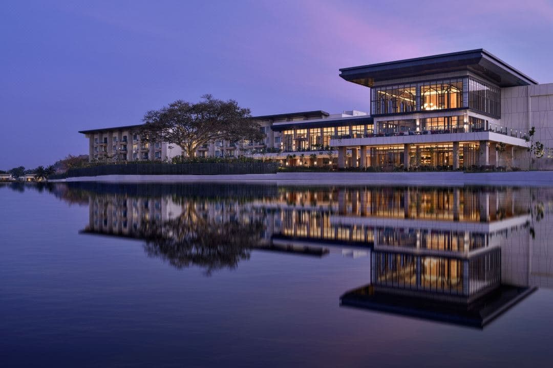 Sunset view over the lagoon pool at JW Marriott Golfshire with Nandi Hills in the background.