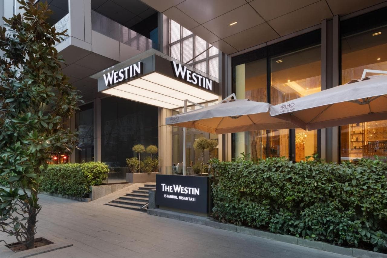 A serene, modern hotel courtyard at The Westin Istanbul Nisantasi featuring vertical gardens and lounge seating.