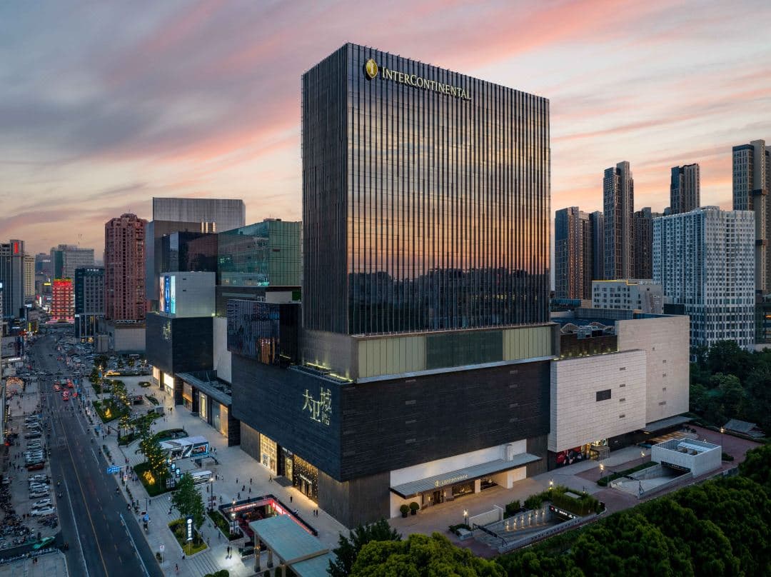 InterContinental Zhengzhou indoor pool with minimalist lighting and city skyline views.