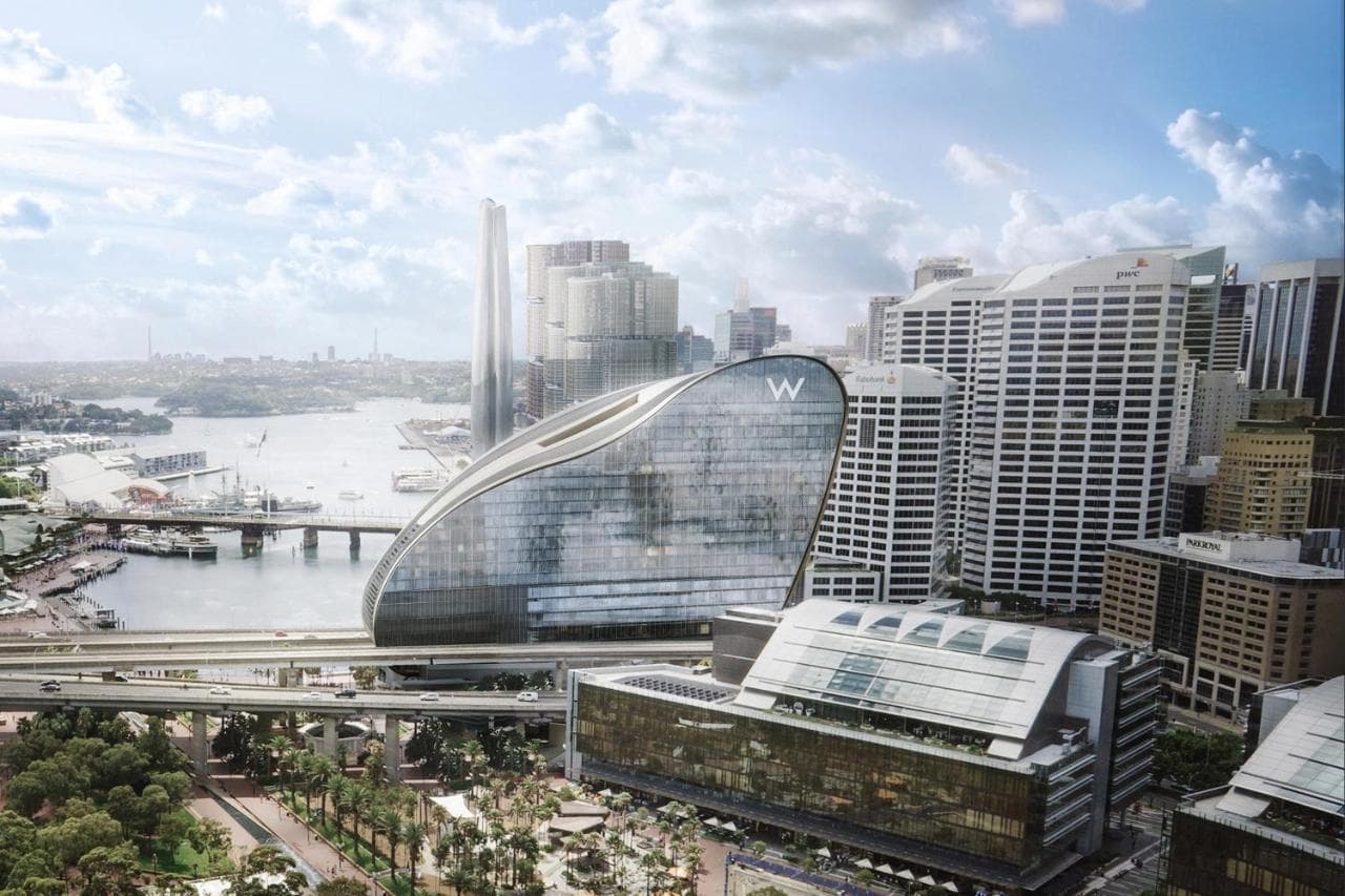 The W Sydney's 29th-floor WET Deck infinity pool at sunrise, featuring a mosaic jellyfish design and overlooking Darling Harbour.