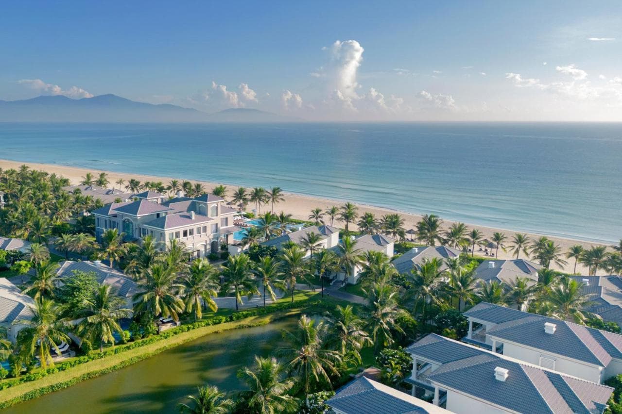 Private pool deck at Danang Marriott Non Nuoc Beach Villas with sun loungers and tropical landscaping.
