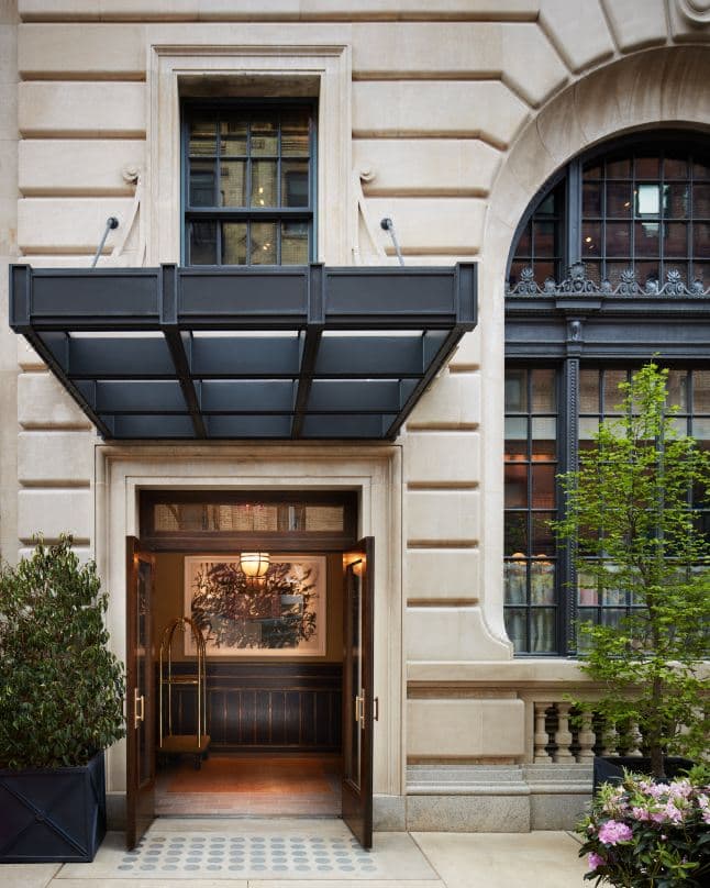 The Swan Room at Nine Orchard featuring a vaulted ornamental ceiling, arched windows, and marble walls in a former bank teller hall.