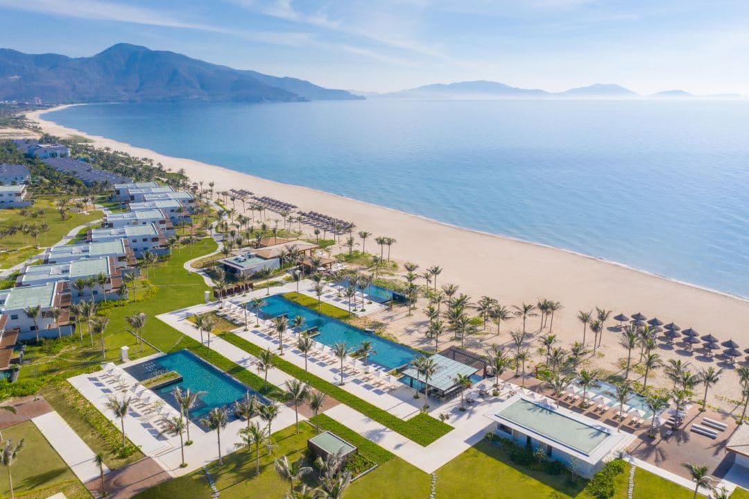 Aerial view of Alma Resort Cam Ranh showing 12 cascading swimming pools leading down to the white sands of Bai Dai Beach.