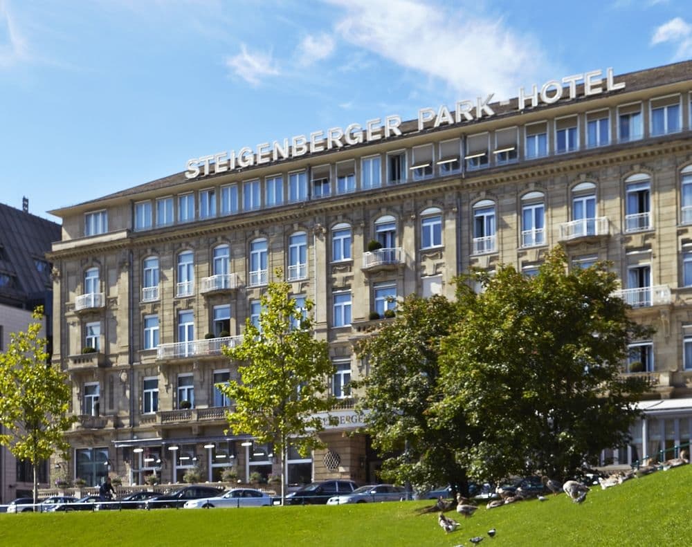 Elegant terrace of Jones Brasserie at Steigenberger Icon Parkhotel overlooking the Hofgarten park.