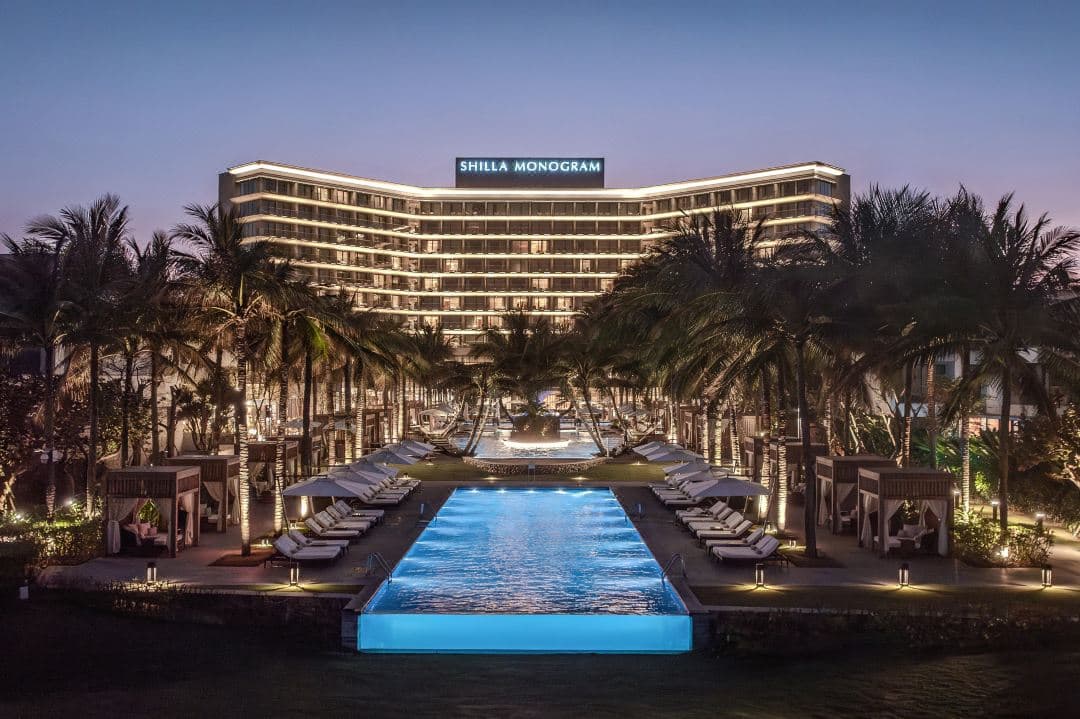 The adult infinity pool at Shilla Monogram Danang with a glass wall overlooking the ocean.
