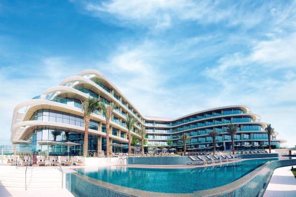 The 800-year-old olive tree standing as the centerpiece of the modern, light-filled atrium at JA Lake View Hotel Dubai.