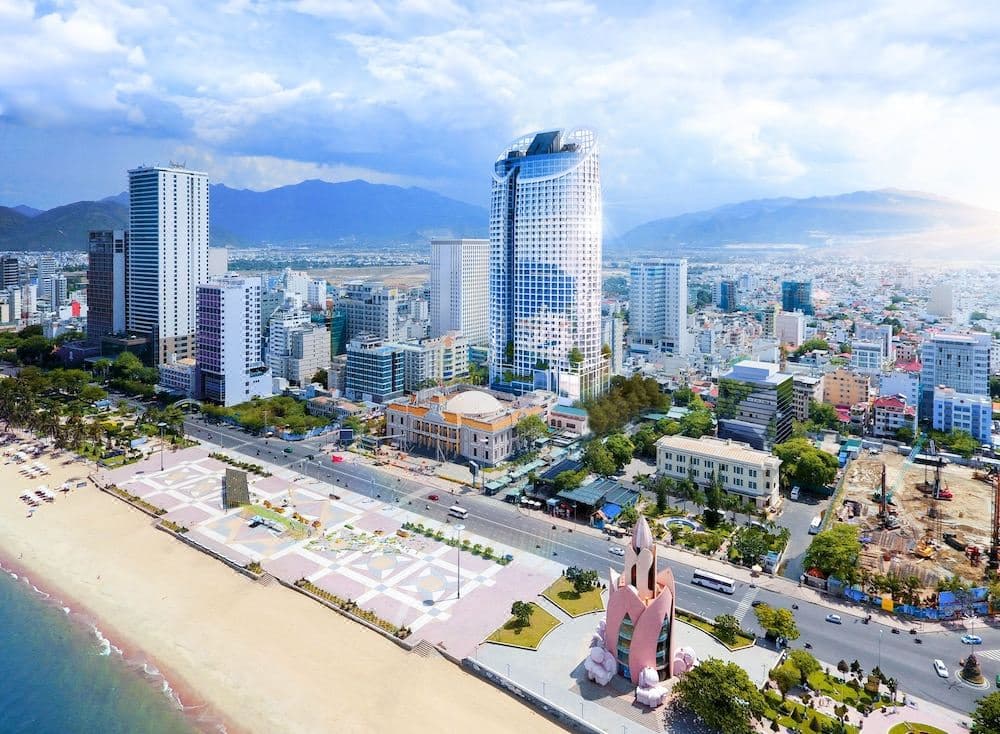 A swimmer floating over the glass-bottom section of the Sky Blu infinity pool on the 40th floor, with the Nha Trang city streets visible hundreds of feet directly below.