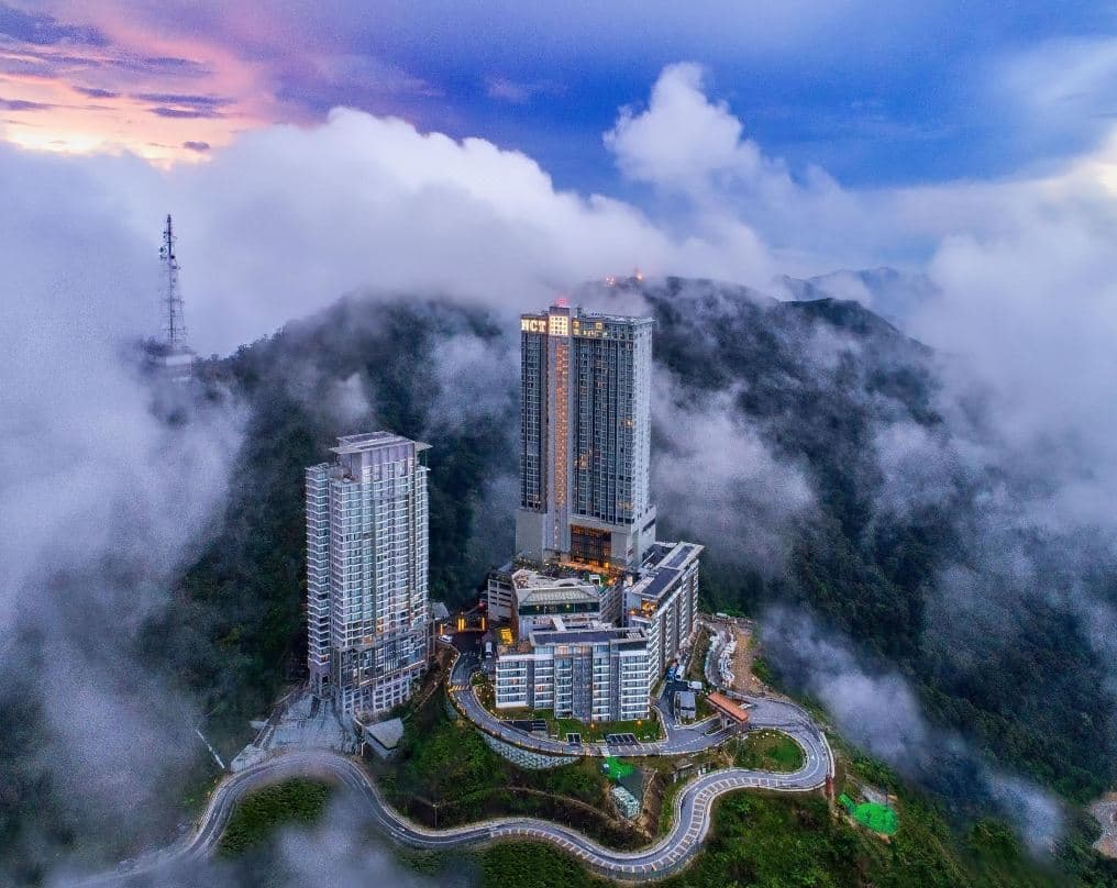 Grand Ion Delemen Hotel towers emerging from a thick sea of clouds in Genting Highlands.