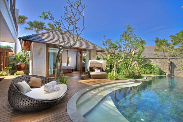 A 12-meter private swimming pool at The Akasha Luxury Villas surrounded by frangipani trees and a Balinese gazebo.