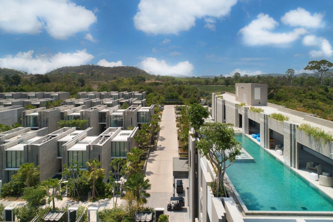 A modern, geometric concrete pool villa at Cross Pattaya Oceanphere with a private plunge pool and tropical landscaping.