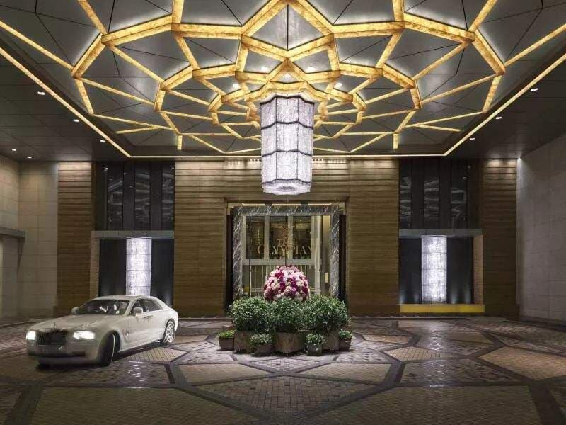 The Olympian Hong Kong lobby featuring a six-tier crystal chandelier and high-gloss marble flooring.