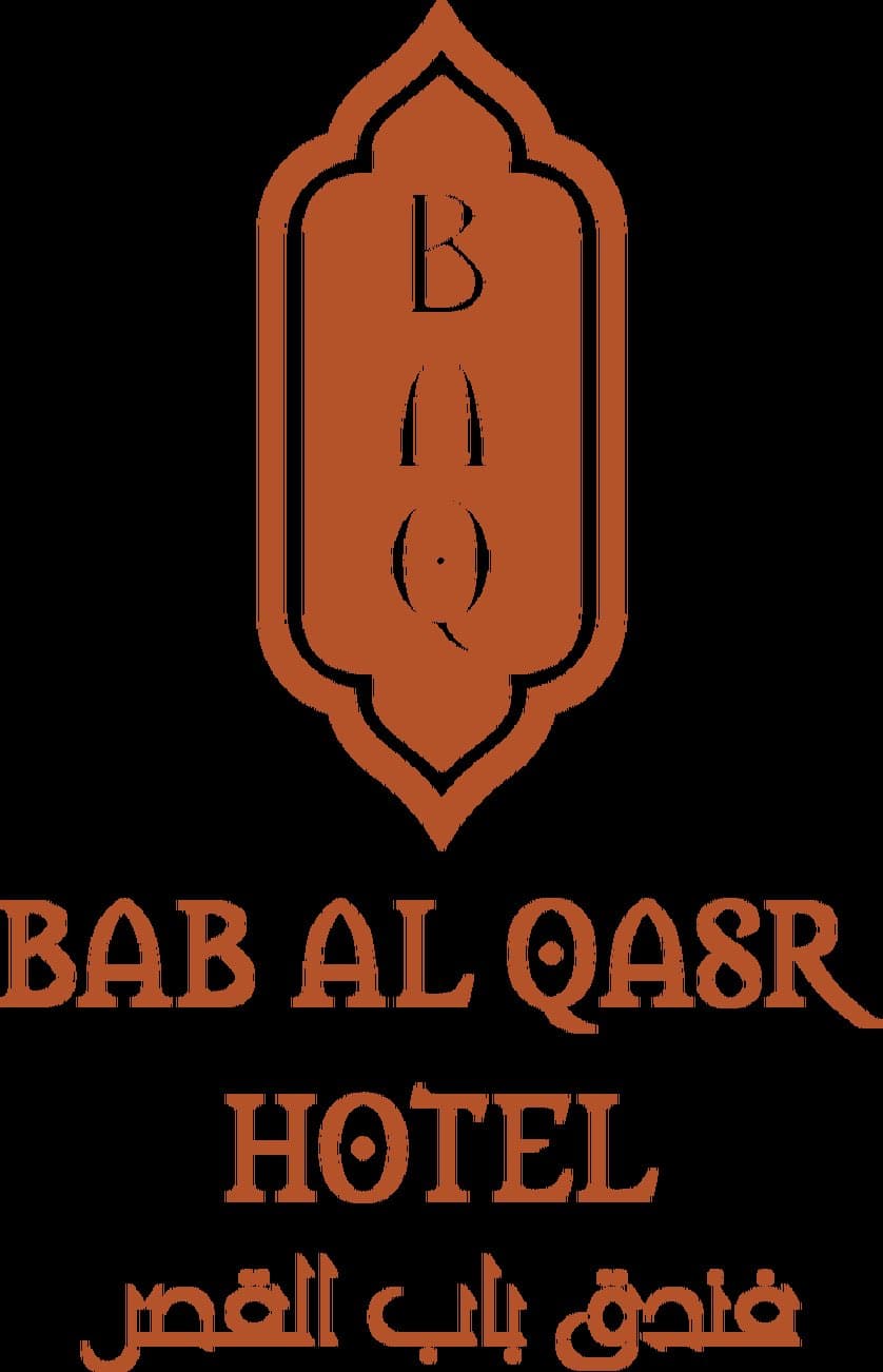 Bab Al Qasr Hotel's twin copper towers glowing orange at sunset against the Abu Dhabi Corniche skyline.
