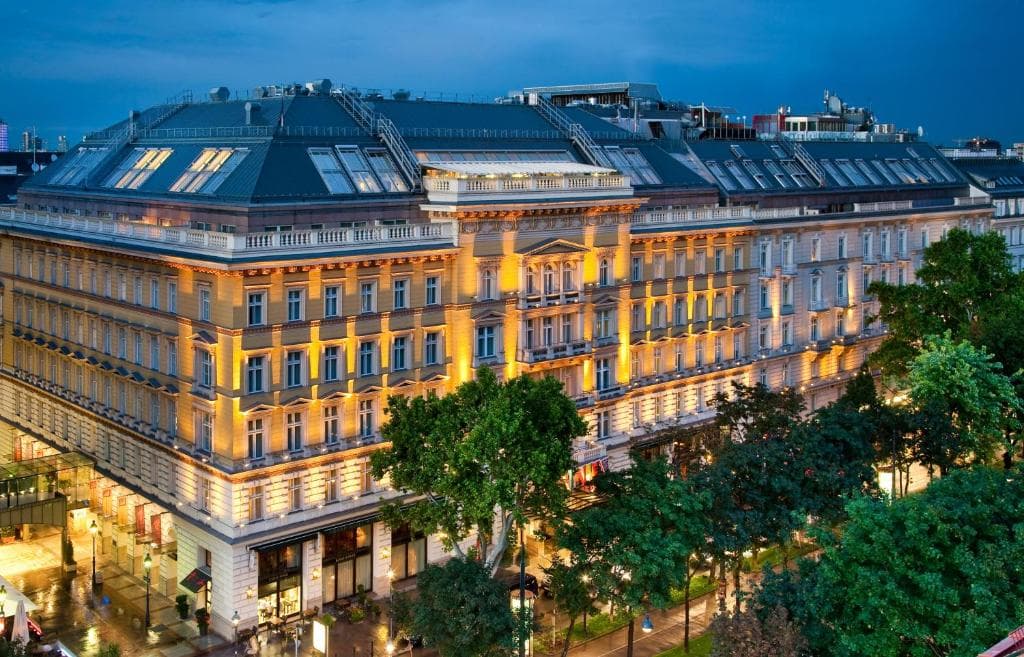 Grand Hotel Wien lobby featuring a grand staircase and a massive crystal chandelier.