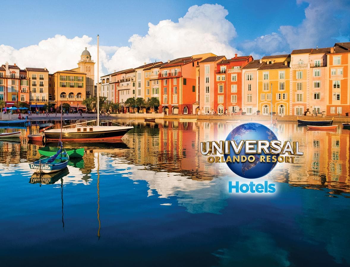 A sun-drenched view of the Loews Portofino Bay Harbor Piazza with Italianate facades, docked water taxis, and palm trees reflecting in the water.