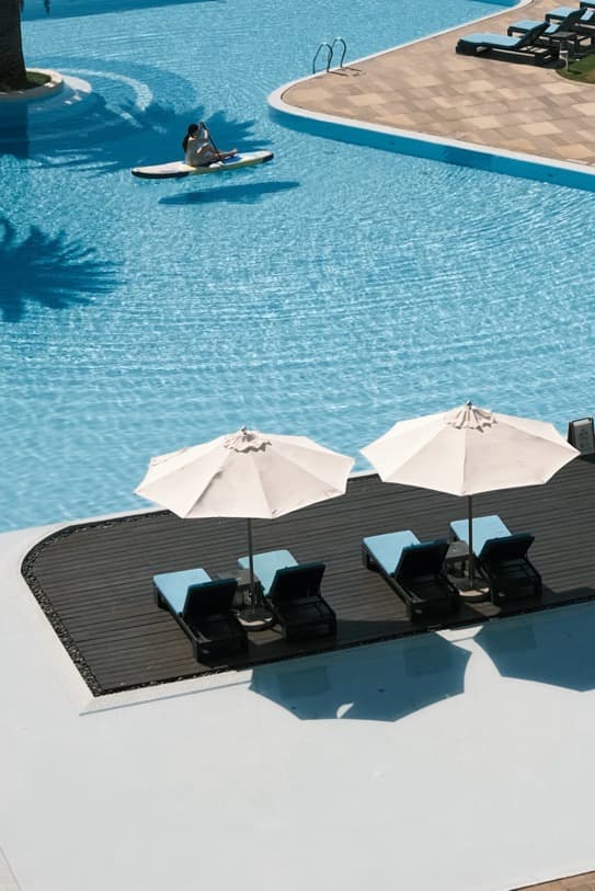 The Shanhaitian Resort Sanya with modern towers, palm trees, pool, and South China Sea views