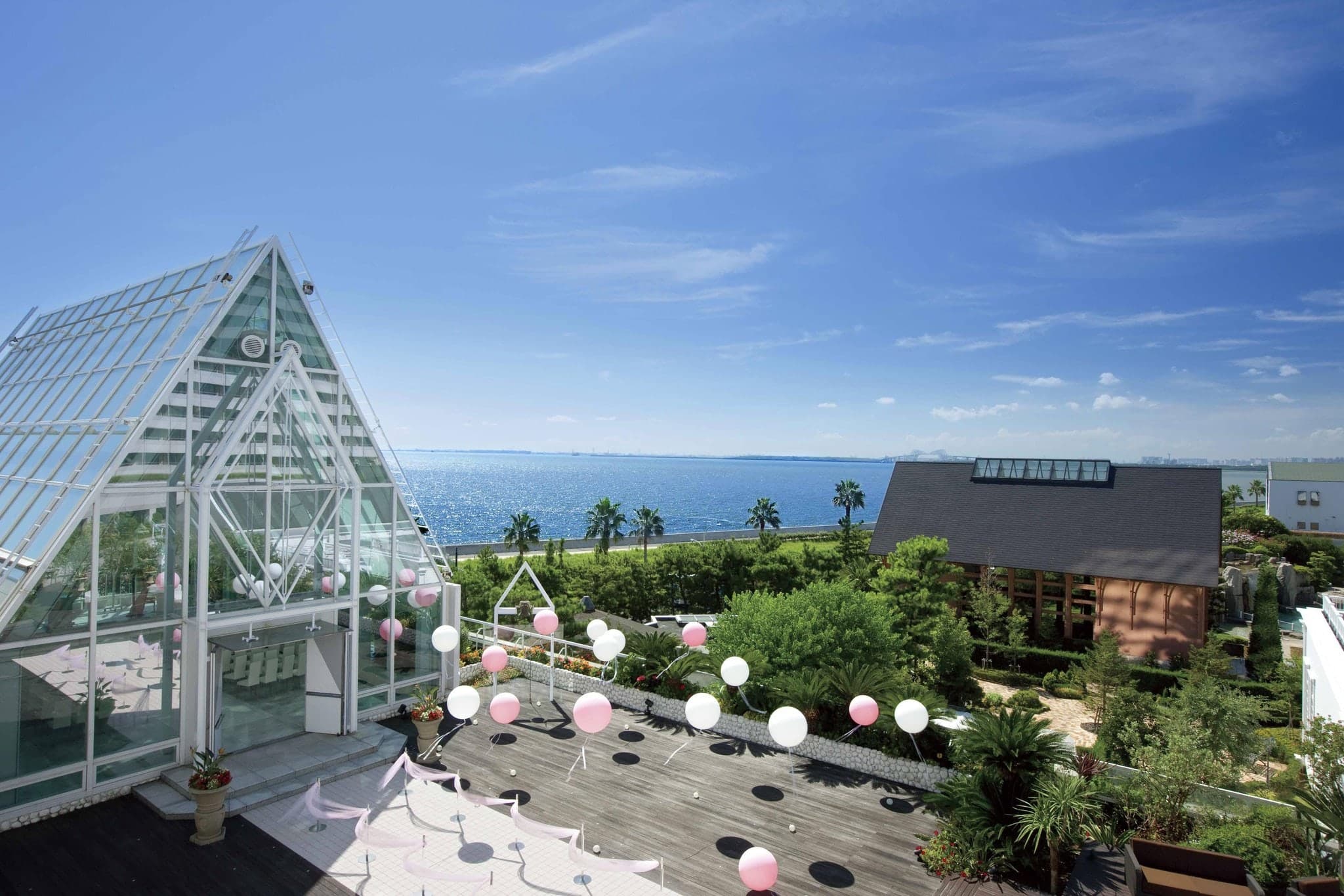 The curvaceous, modern exterior of Sheraton Grande Tokyo Bay Hotel overlooking the garden pool and waterfall.