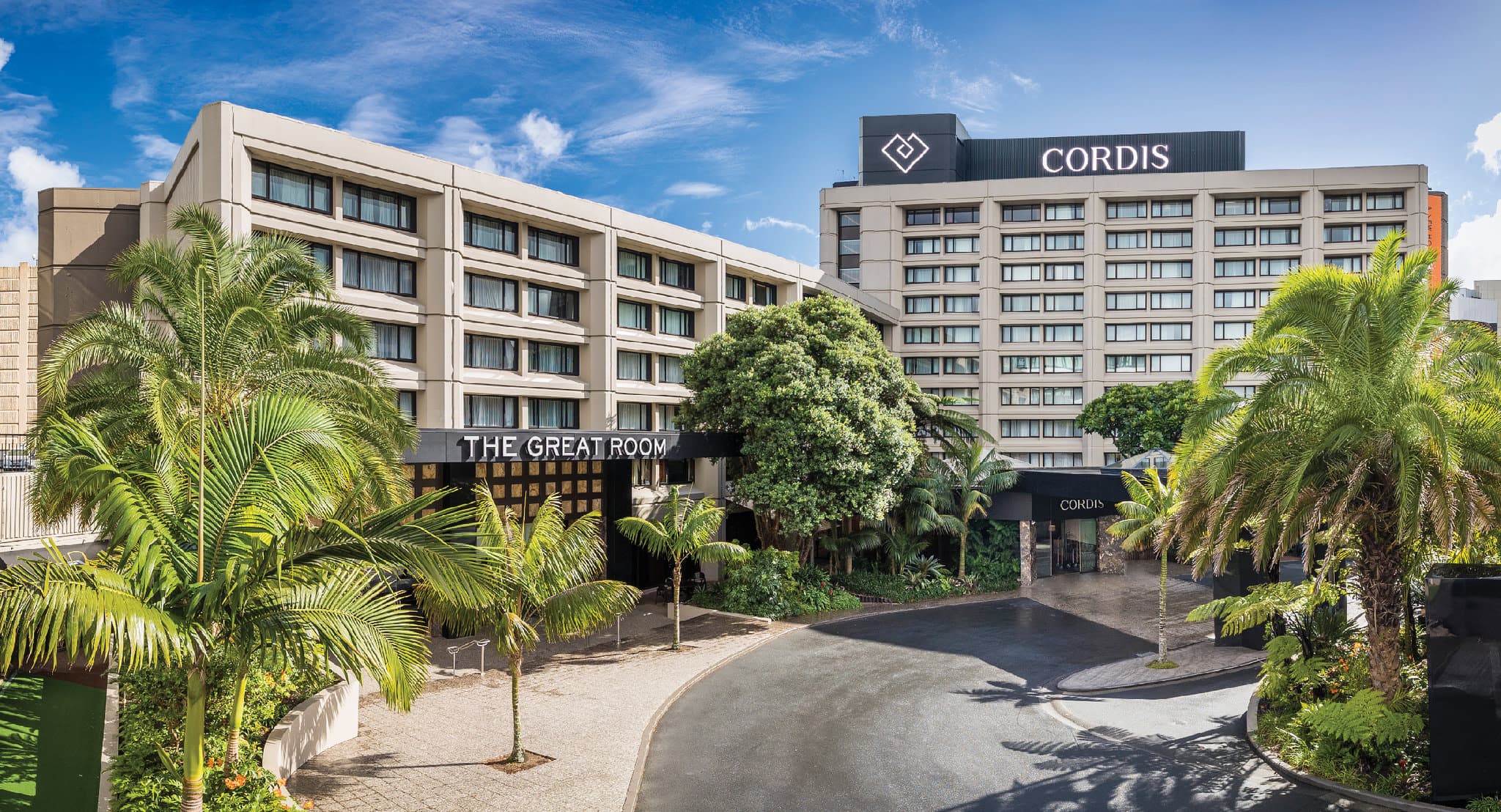 The Chandelier Lounge at Cordis Auckland featuring a massive golden chandelier and plush high-tea seating.