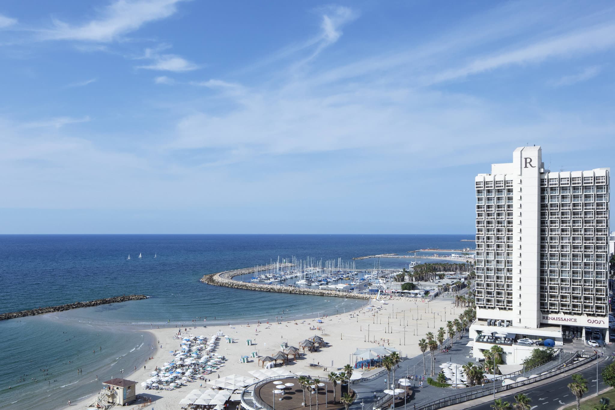 View from a Renaissance Tel Aviv private balcony looking directly down at the Gordon Beach shoreline.