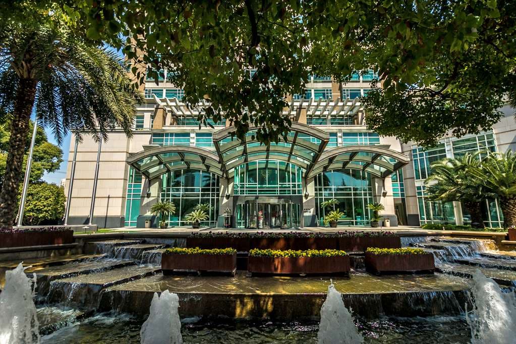 The iconic Villa 1 'Little White Palace' at Radisson Collection Xing Guo Shanghai surrounded by lush green lawns.