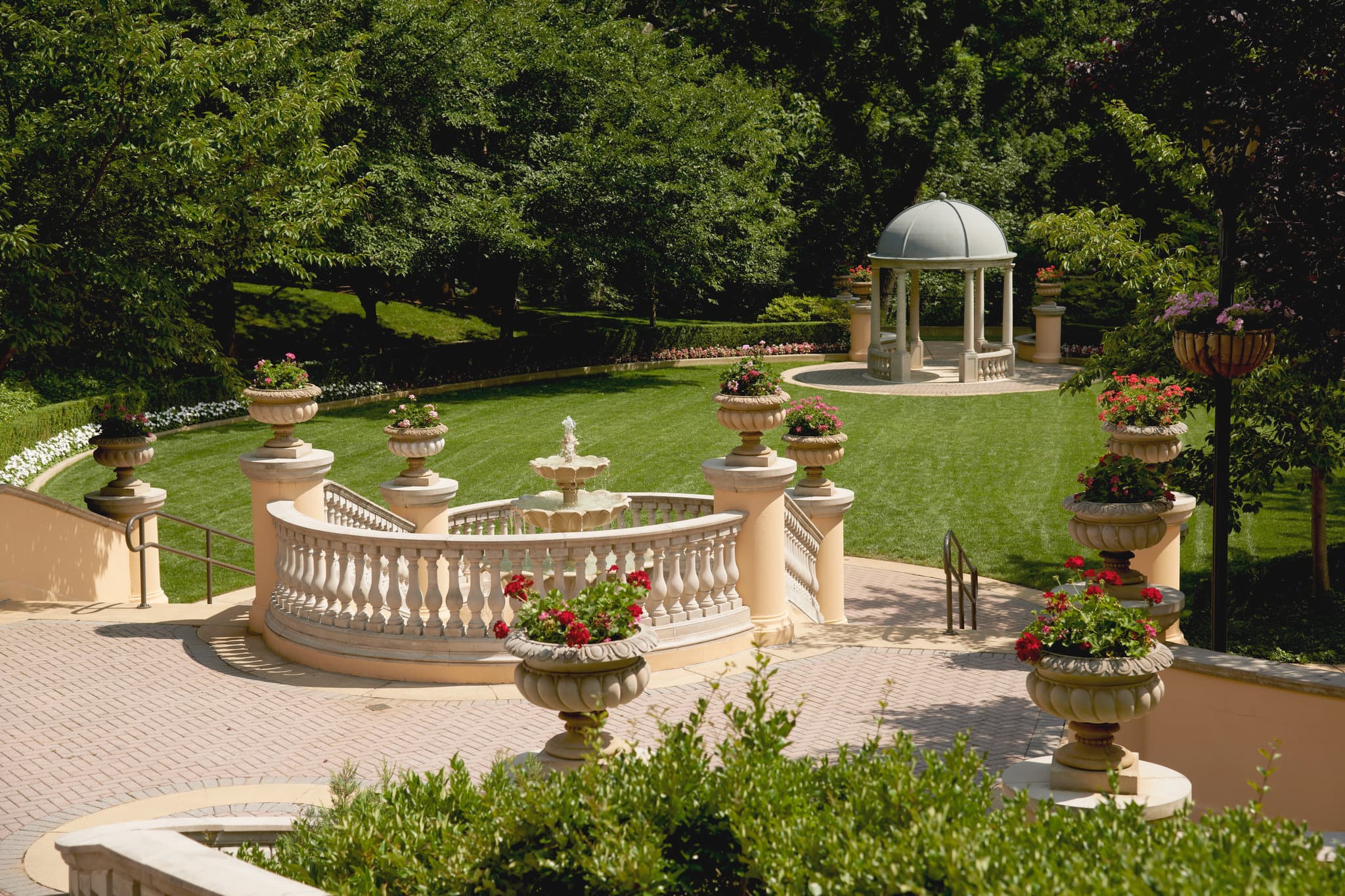 A twilight view of the Omni Shoreham Hotel's heated outdoor resort pool surrounded by 11 acres of manicured gardens.