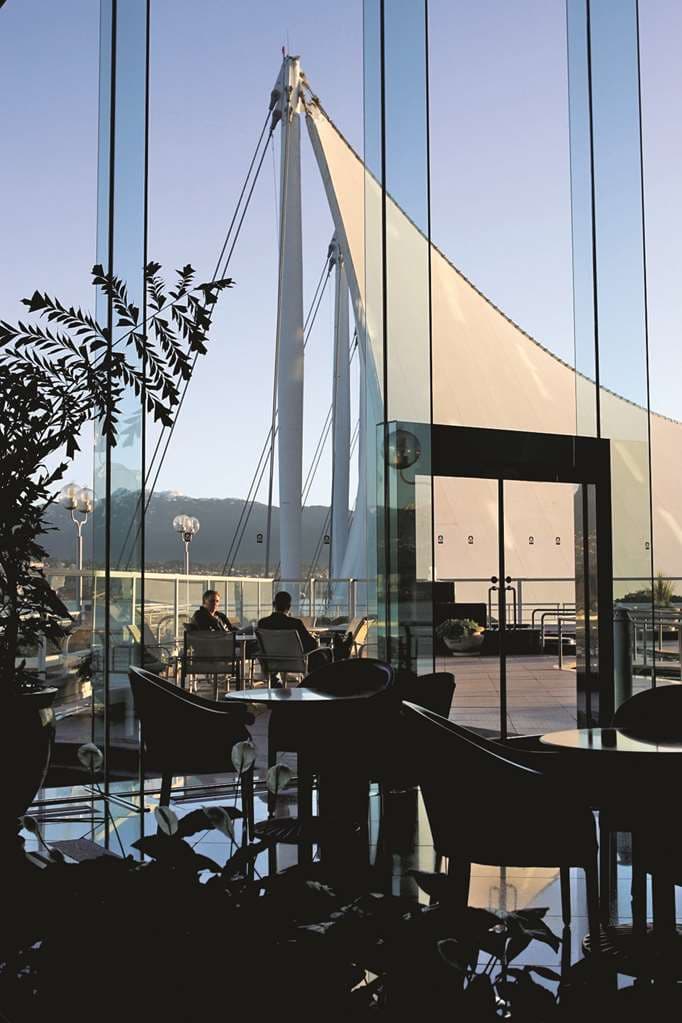 Pan Pacific Vancouver's heated rooftop saltwater pool with steam rising, overlooking the North Shore mountains and Coal Harbour.