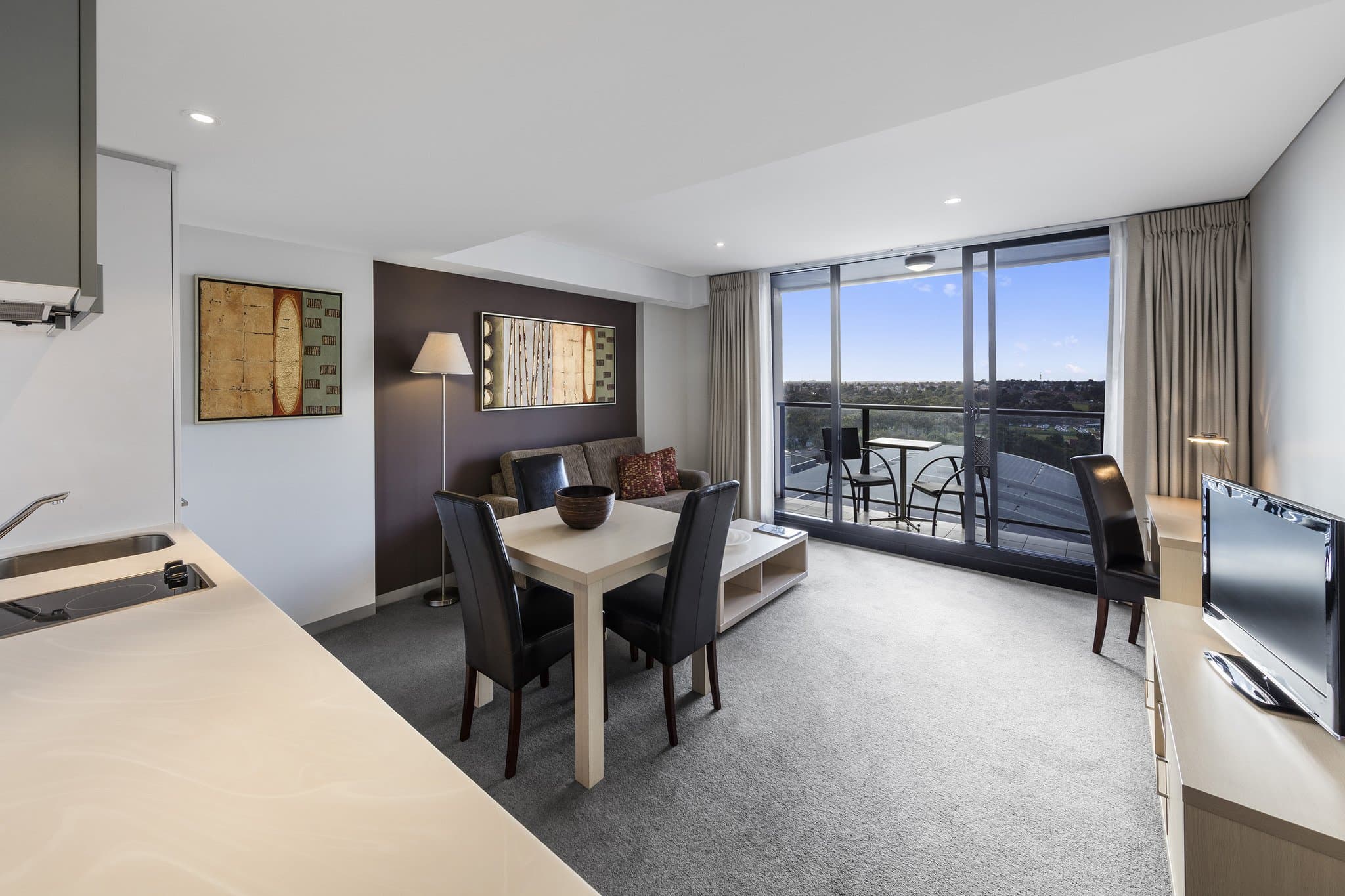 A spacious North-facing suite balcony at Oaks Adelaide Horizons Suites overlooking the Adelaide Riverbank and Oval precinct.