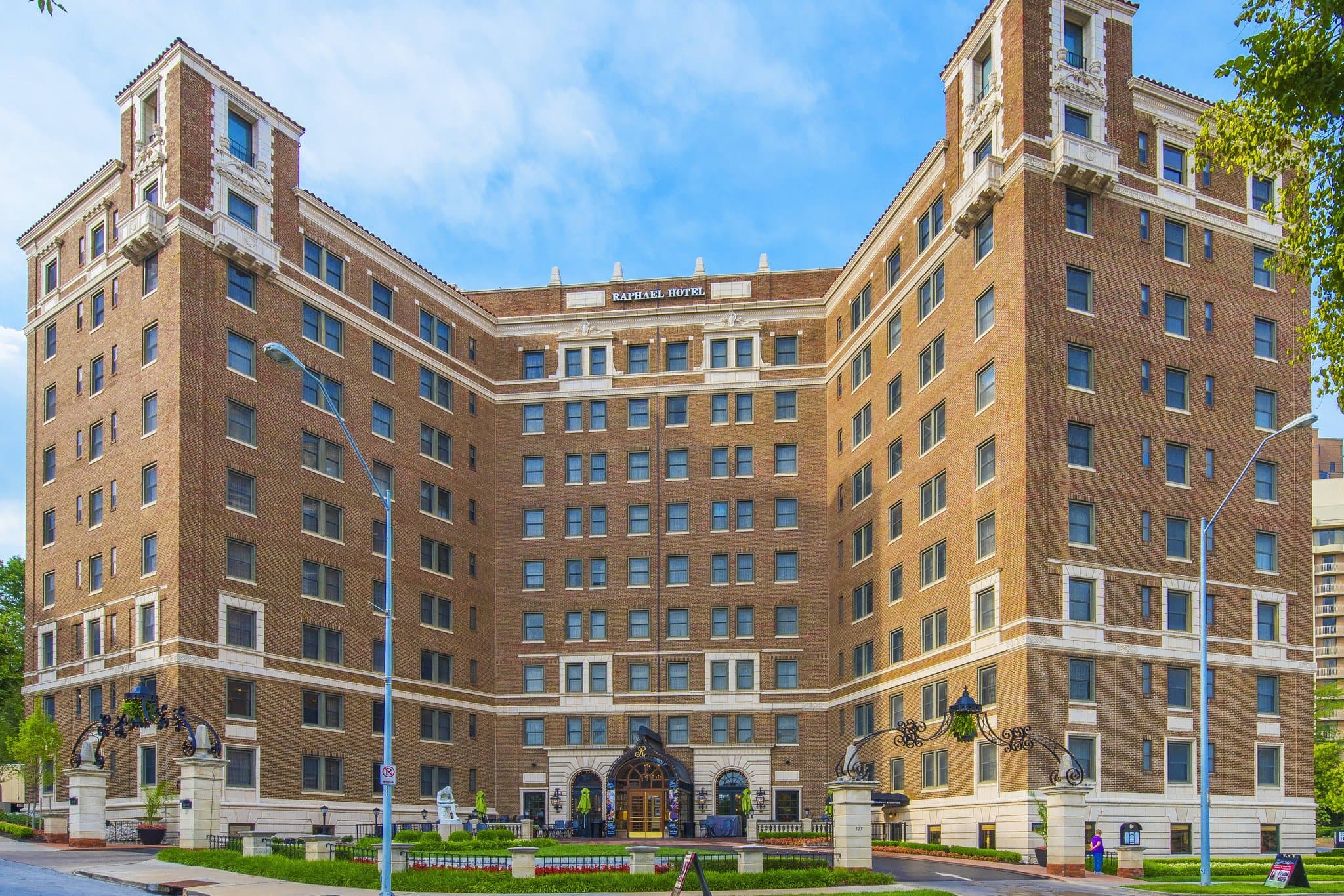 The Raphael Hotel exterior at night featuring Italian Renaissance Revival architecture and illuminated Country Club Plaza background.