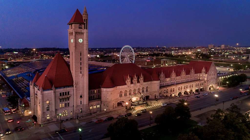 The cavernous Grand Hall at St. Louis Union Station Hotel, featuring a barrel-vaulted ceiling illuminated by 3D projection mapping and Romanesque arches.