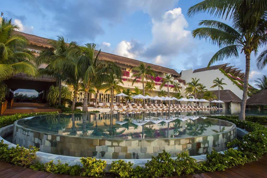 Grand Velas Riviera Maya Zen Grand pool surrounded by lush jungle vegetation.